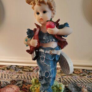 Little Girl in Jeans with a large strawberry in her hands, figurine 9 1/2" Resin